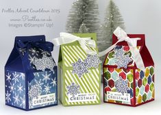 three christmas gift bags with bows and snowflakes on them