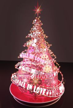 a lighted christmas tree on a plate with words written all over it and a star above the top