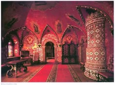 an ornately decorated room with red carpet and walls