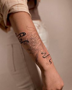 a woman with a flower tattoo on her arm