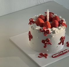 a white cake with strawberries on it