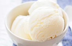 two scoops of ice cream in a white bowl on a blue and white towel