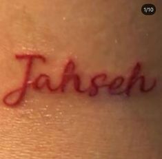 the word jahee written in cursive writing on someone's back shoulder