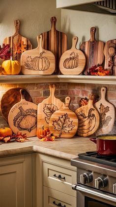 several wooden cutting boards sitting on top of a kitchen counter next to an oven and stove