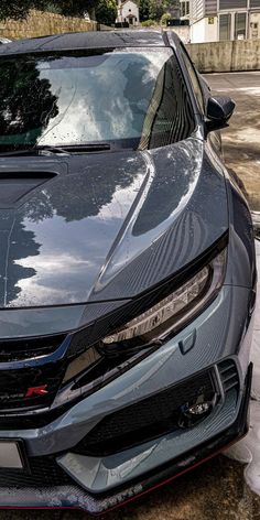 the front end of a gray car parked on snow covered ground