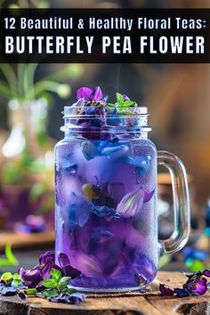 a jar filled with purple flowers sitting on top of a wooden table