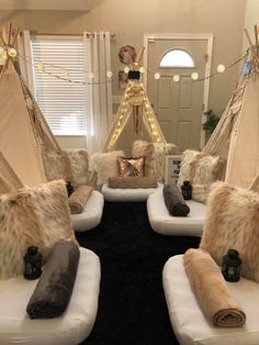 a living room filled with white couches covered in pillows