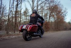 a person riding a motorcycle down the road