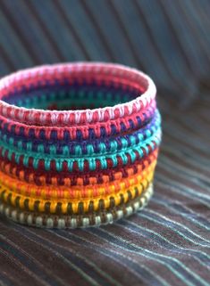 multicolored bracelets stacked on top of each other