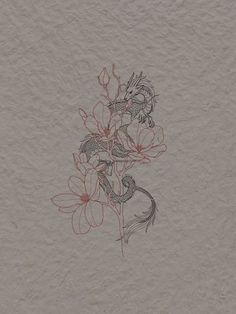 a drawing of flowers on a piece of paper with red ink in the middle, and a bird sitting on top of it