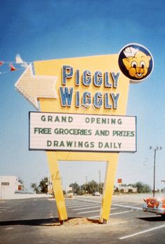 an old photo of a piggly wiggly sign in front of a parking lot