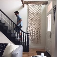 a man is walking down the stairs in his home