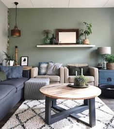 a living room filled with furniture and lots of plants on top of a table in front of a window