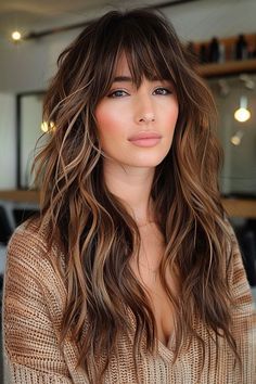 Long Hair with Undone Waves and Fringe This hairstyle exudes a boho-chic vibe with its longundone waves full of texture and a wispy fringe that frames the face with a touch of carefree eleganceThe sunlit balayage brings dimension and depthenhancing the natural flow of the waves—a perfect look for those who love... Wavy Hair Women Haircut, Long Hair With Bangs Highlights, Fringe Inspo Long Hair, Long Hair With Crown Layers, Long Hair With Long Layers And Face Frame, Long Hair With Bangs Balayage, Brunette Hair With Bangs Long, Sag Haircut, Boho Fringe Hair