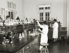 two women in white lab coats are doing experiments