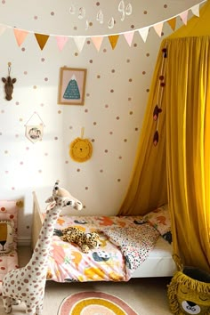 a child's bedroom with yellow drapes and polka dot wallpaper on the walls