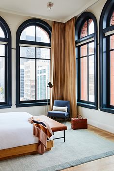 a hotel room with large windows and a bed