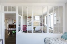 a living room filled with furniture and lots of windows