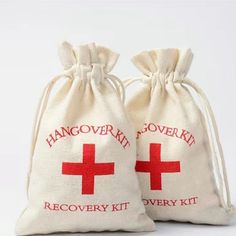 two bags with red crosses on them sitting next to each other