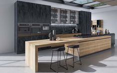 a modern kitchen with an island counter and bar stools