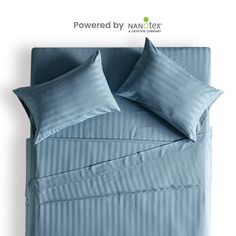 a bed with blue sheets and pillows is shown in front of a white background that says powered by nanc tex