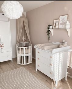 a baby's room with a crib and dresser