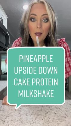 a woman holding up a sign that says pineapple upside down cake protein milkshake