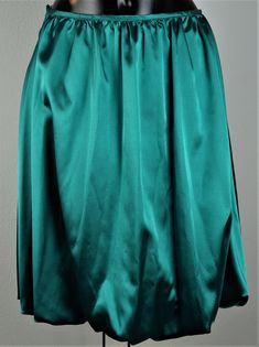 Balloon skirt emerald green Length 55 cm, waist 39 cm Wash at 30o Formal Green Flowy Skirt, Green Flowy Formal Skirt, Green Flowy Skirt For Party, Green Flared Skirt For Formal Occasions, Formal Green Lined Skirt, Formal Green Pleated Skirt, Elegant Green Full Skirt Bottoms, Elegant Green Skirt For Night Out, Green Lined Skirt For Formal Occasions