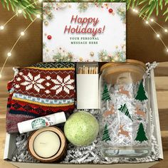 the holiday gift box is packed with personal care items and candles, along with an ornament