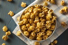 a bowl filled with popcorn on top of a table