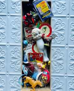 a box filled with lots of assorted toys and knick knacks on top of a table