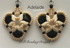 a pair of earrings with black and white beaded details on the back of them