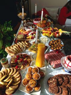 a table filled with lots of food and desserts