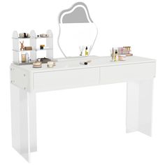 a white dressing table with a mirror and cosmetics on it