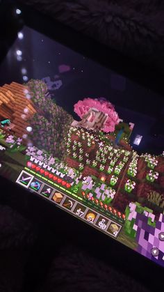 an image of a video game being played on a computer screen with purple flowers and trees