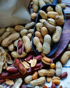 peanuts and other nuts on a wooden spoon