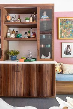 a wooden cabinet sitting next to a couch in a living room