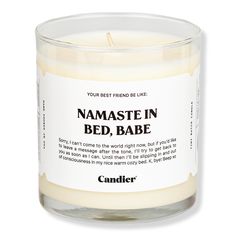 a candle that says namaste in bed, babe on the front and side