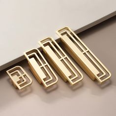 four pieces of brass metal on a table