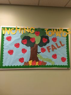 a bulletin board with an apple tree and the words watching towardss fall on it