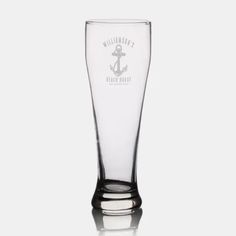 a tall glass with an anchor on it