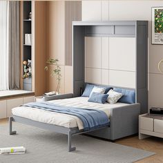 a bed sitting in the middle of a living room next to a book shelf and window