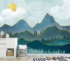 a room with mountains and trees painted on the wall next to a white dresser in front of it