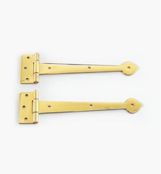 two brass - plated door handles on a white background