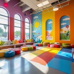 the children's playroom is brightly colored and has lots of windows