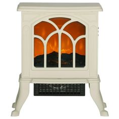 a white stove with an orange fire in the front and side windows on each side