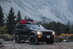 a black jeep parked on the side of a mountain