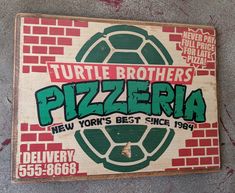 there is a sign that says turtle brothers pizzaria in front of a brick wall