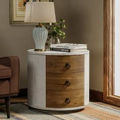 a round table with drawers and a lamp on top