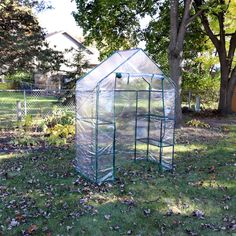 Have a successful growing season with help from this portable walk-in greenhouse! With four shelves for growing plants and storing supplies, this greenhouse for use out on the patio, deck, yard, in the garden, or other outdoor area, is perfect for creating the ideal growing climate for all your favorite vegetables, herbs, fruits, and flowers. This greenhouse is durably constructed from an iron tube frame with a steel wire shelf and a polyethylene covering coated with a UV ray protective finish. The cover of this walk-in greenhouse protects plants from inclement weather, like frost, excessive heat, and too much moisture. The cover is transparent so light can filter through to ensure plants receive the perfect amount of sunlight needed to grow. A roll-up door with zippers allows you to contr Hobby Greenhouse, Outdoor Greenhouse, Portable Garden, Garden Hose Reel, Portable Greenhouse, Walk In Greenhouse, Potting Tables, Wire Shelves, Fruits And Flowers